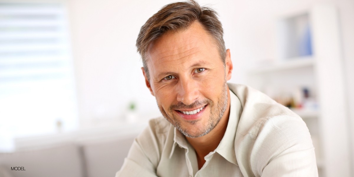 Male smiling with light tan shirt