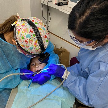 Photo of Patty working on a patient